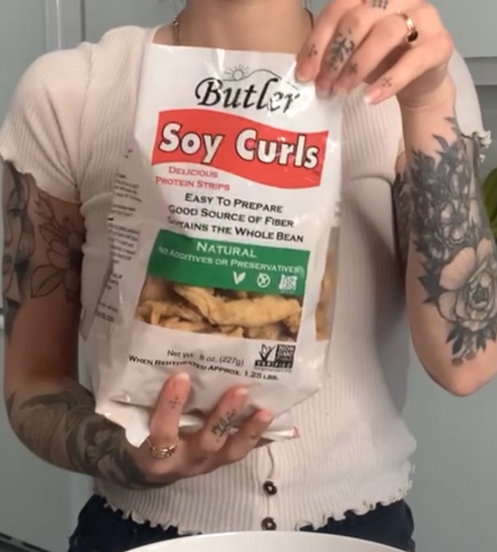That Chickpea holding a white bag of Butler Soy Curls.
